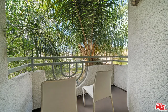 a balcony with table and chairs