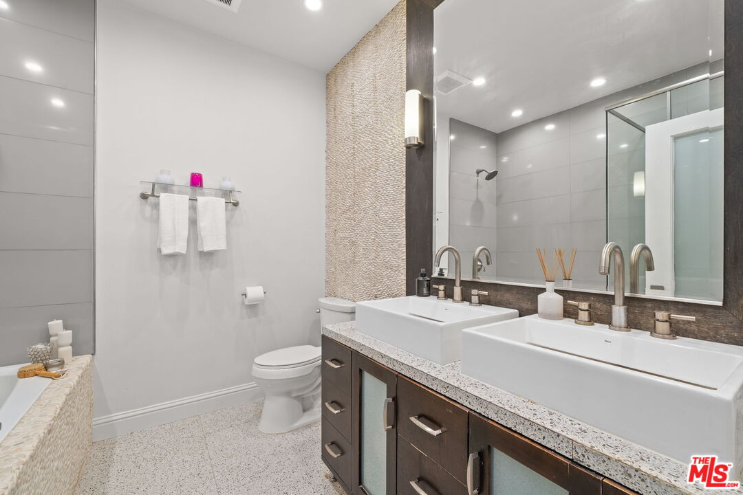 11822 Goshen Avenue, Unit 301 Los Angeles, CA 90049 - Photo 17 of 29 a bathroom with a sink and a mirror