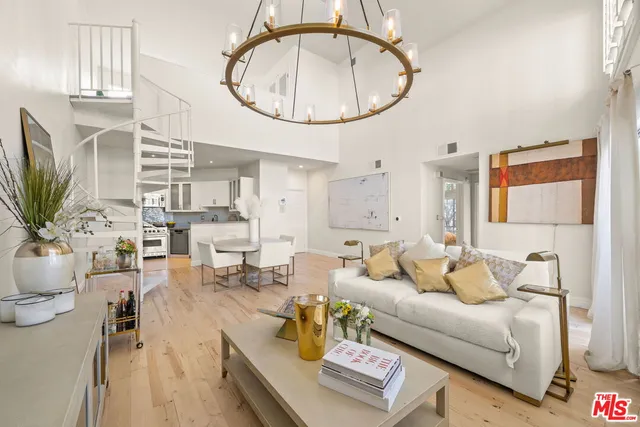 a living room with furniture a flat screen tv and a window