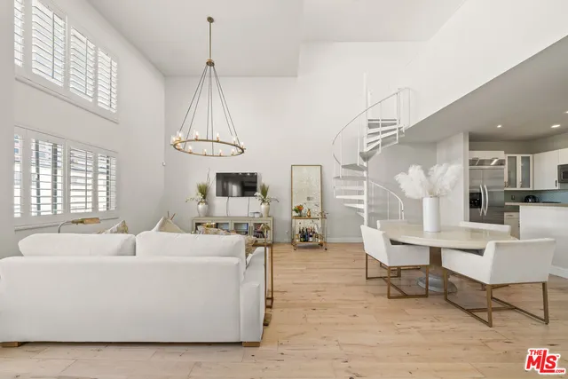 a living room with furniture a table and a chandelier
