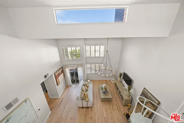 a view of a workspace with furniture and wooden floor