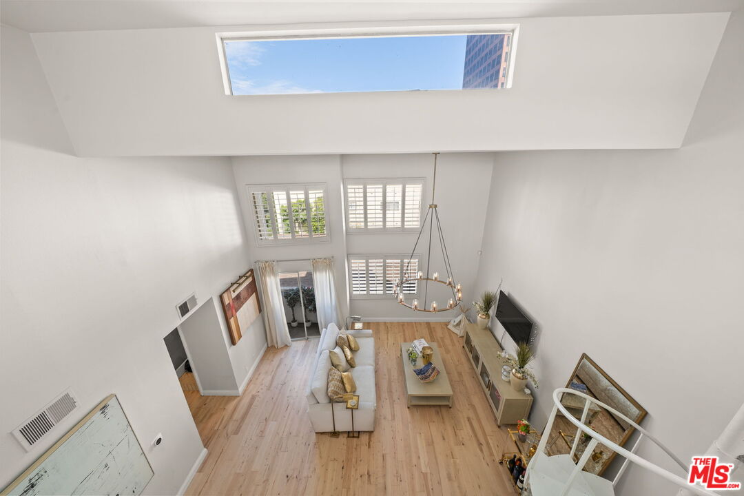11822 Goshen Avenue, Unit 301 Los Angeles, CA 90049 - Photo 6 of 29 a view of a workspace with furniture and wooden floor