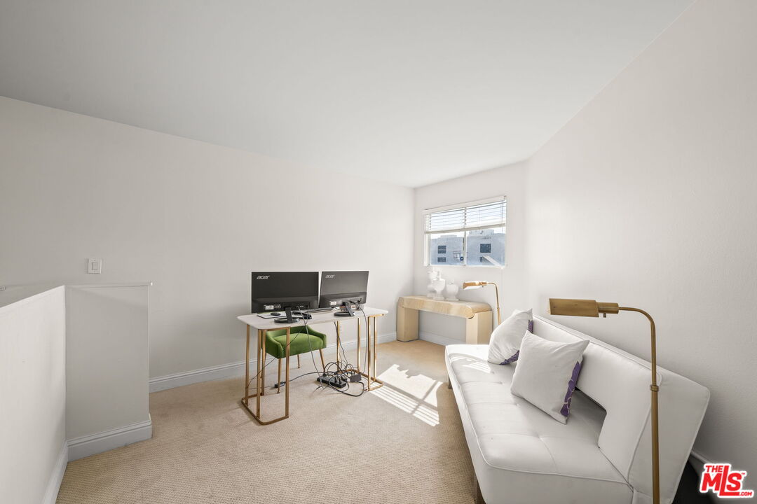 11822 Goshen Avenue, Unit 301 Los Angeles, CA 90049 - Photo 7 of 29 a living room with furniture and a flat screen tv