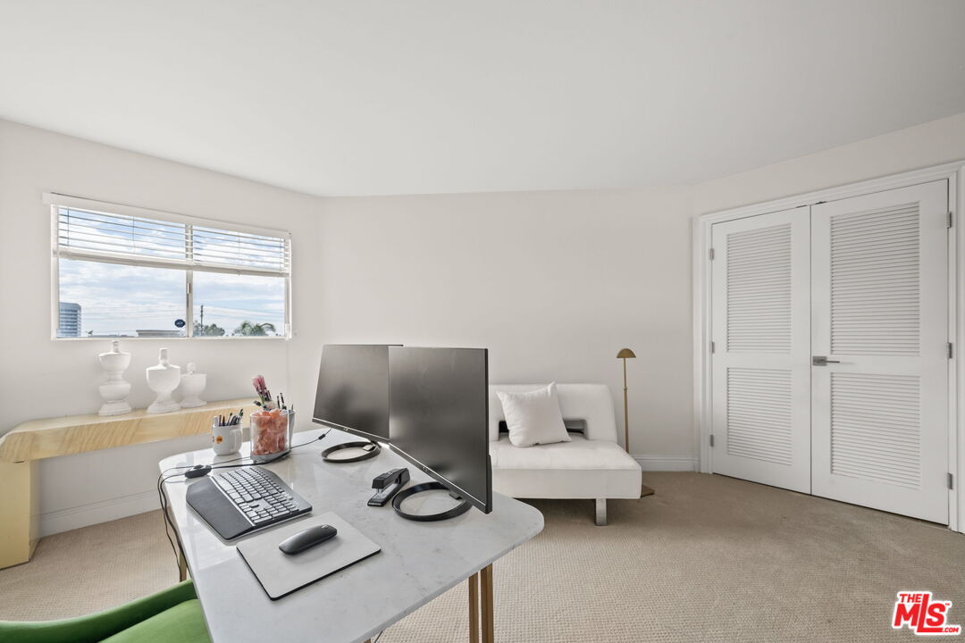 11822 Goshen Avenue, Unit 301 Los Angeles, CA 90049 - Photo 8 of 29 a living room with furniture and a window