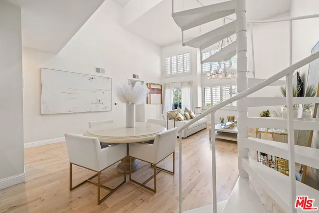 a view of a livingroom with furniture window and wooden floor