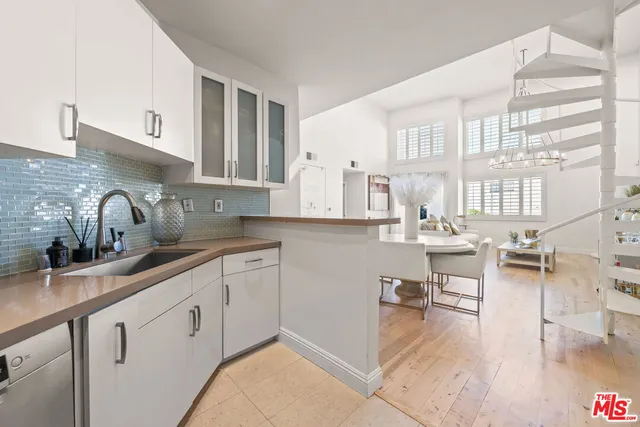 a kitchen with sink and cabinets