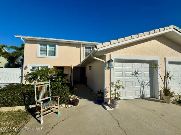 a view of a patio with a table and chairs and potted plants