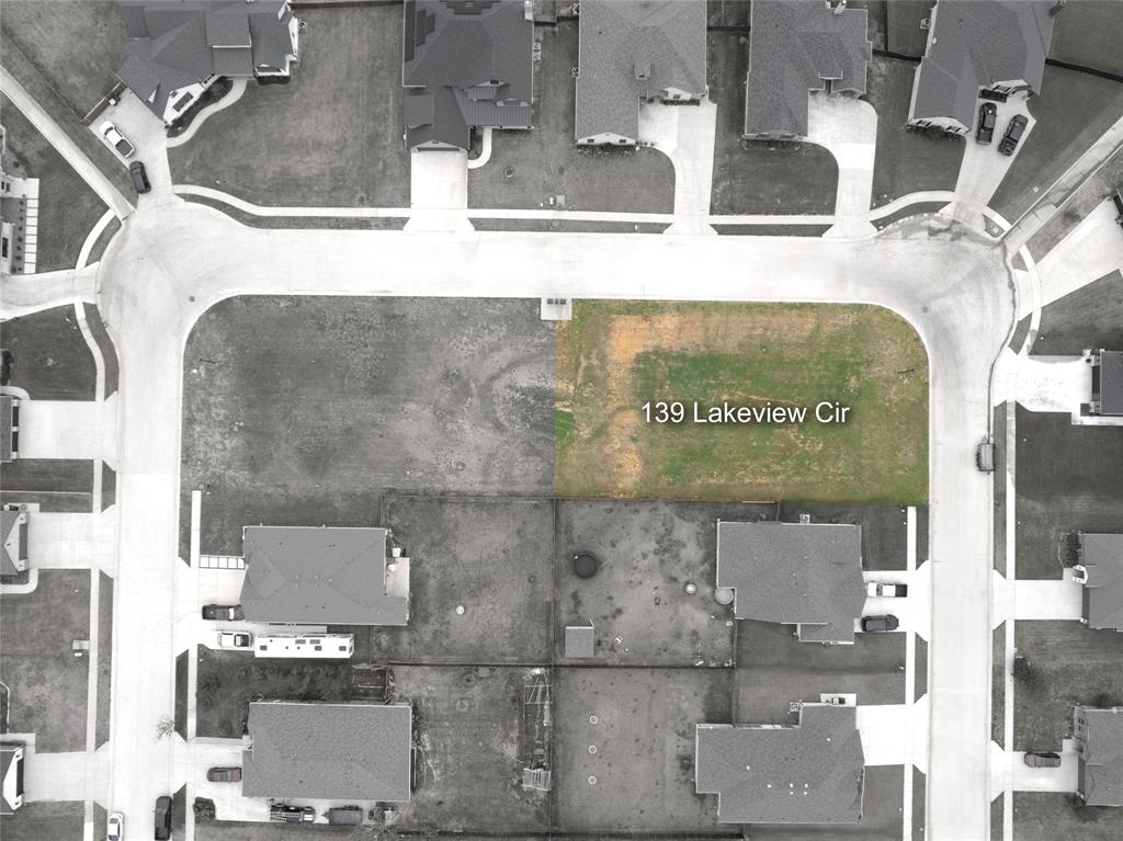 139 Lakeview Circle Pilot Point, TX 76258 - Photo 14 of 19 Aerial view of a vacant lot at 139 Lakeview Cir, featuring clear street frontage, a curvilinear street layout, and surrounding residential properties