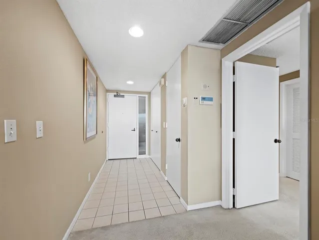 a view of a hallway with wooden floor and closet
