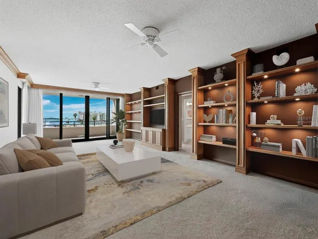 a living room with furniture cabinets and flat screen tv