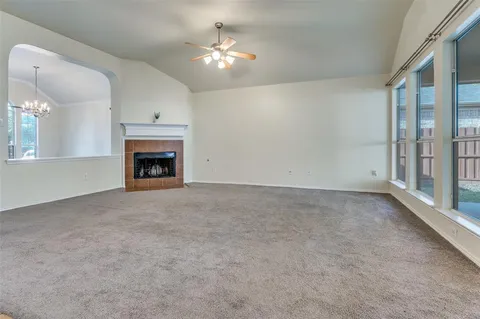 a view of an empty room with a fireplace