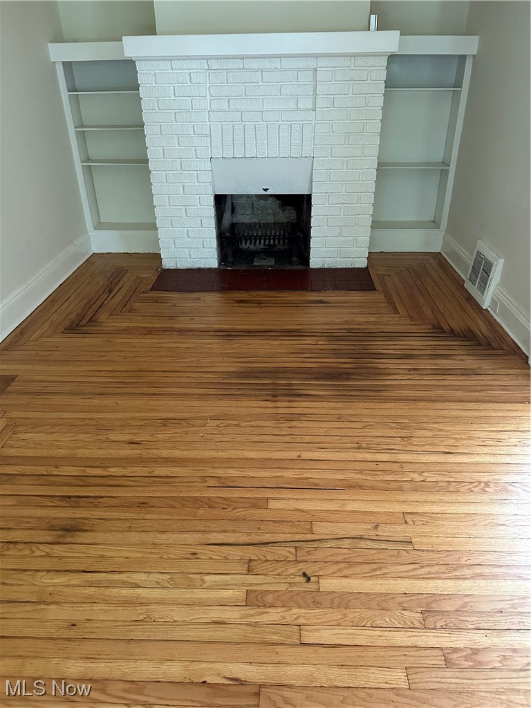 1596 Wood Road Cleveland Heights, OH 44121 - Photo 20 of 25 Detailed view of a fireplace and parquet flooring
