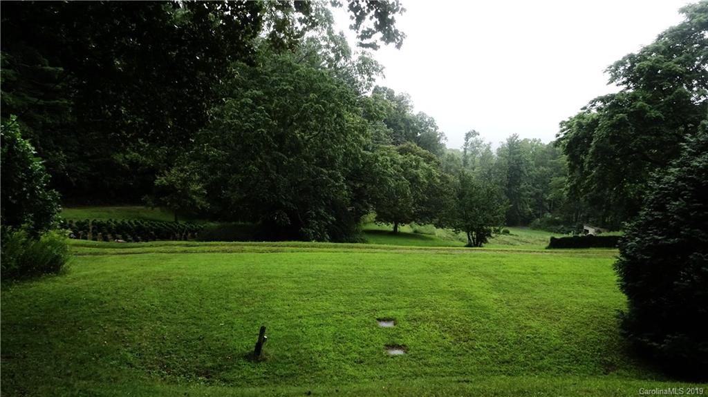 360 Banjo Branch Road Burnsville, NC 28714 - Photo 2 of 17 a view of a grassy field with trees
