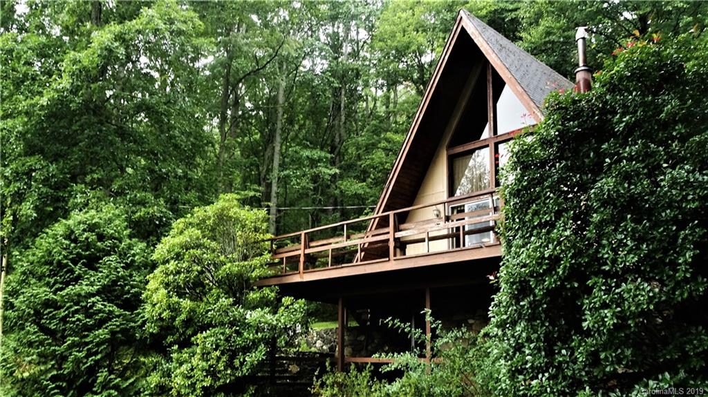 360 Banjo Branch Road Burnsville, NC 28714 - Photo 17 of 17 a view of a wooden house with a small yard and wooden deck