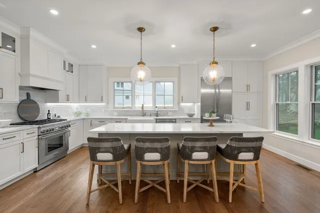 a living room with furniture and a dining table with kitchen view