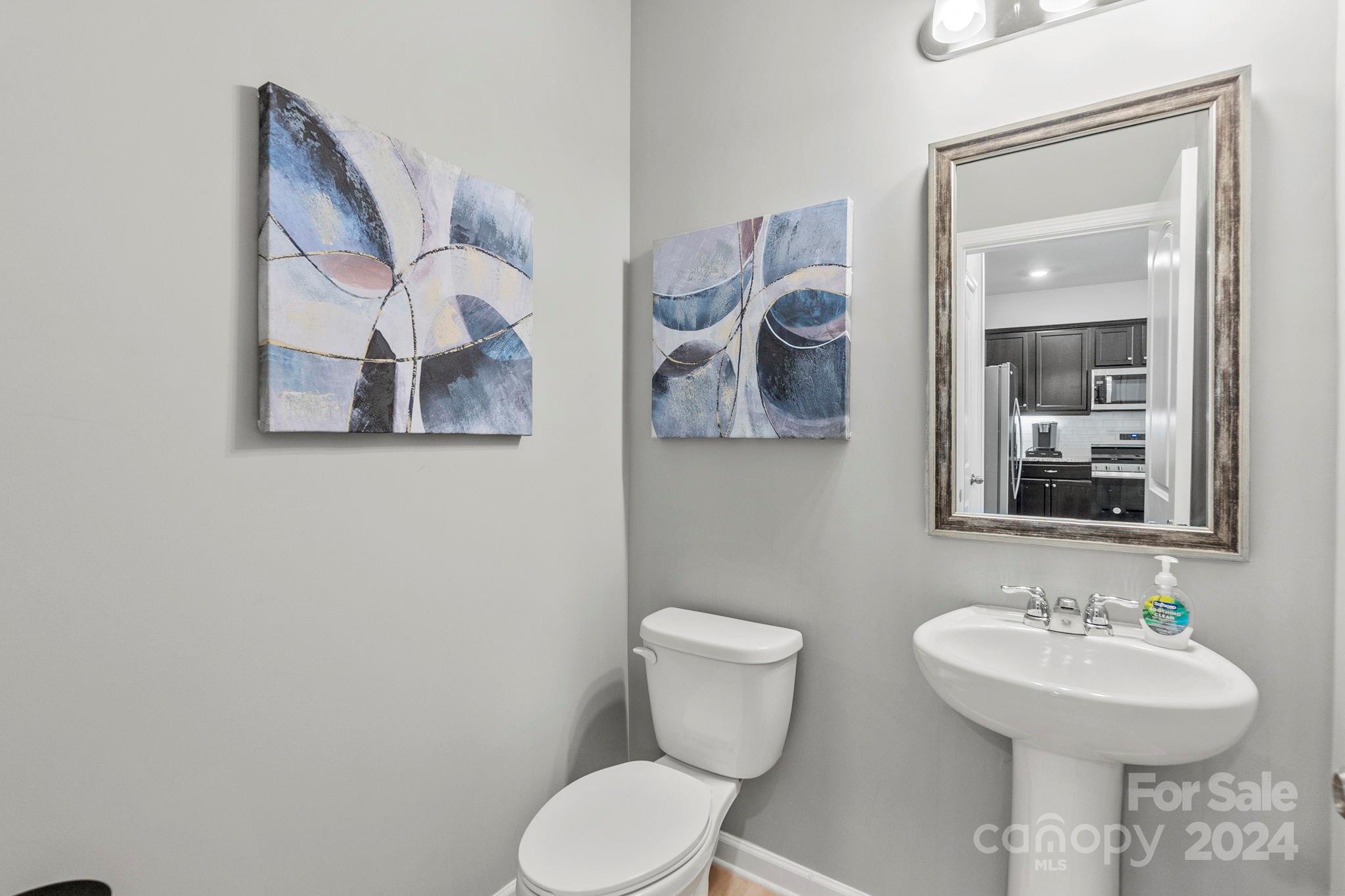 7902 Nelson Road Mint Hill, NC 28227 - Photo 11 of 30 a bathroom with a toilet sink and mirror