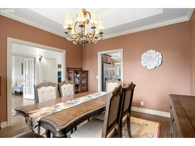 a dining room with furniture and chandelier