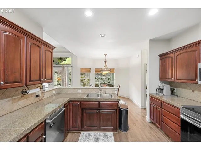 a kitchen with a sink stove and cabinets