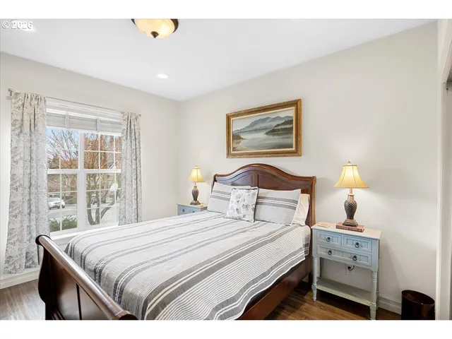 a bedroom with a bed and a painting on the wall