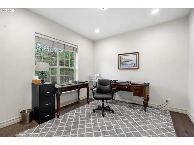 a view of washer and dryer with wooden cabinets