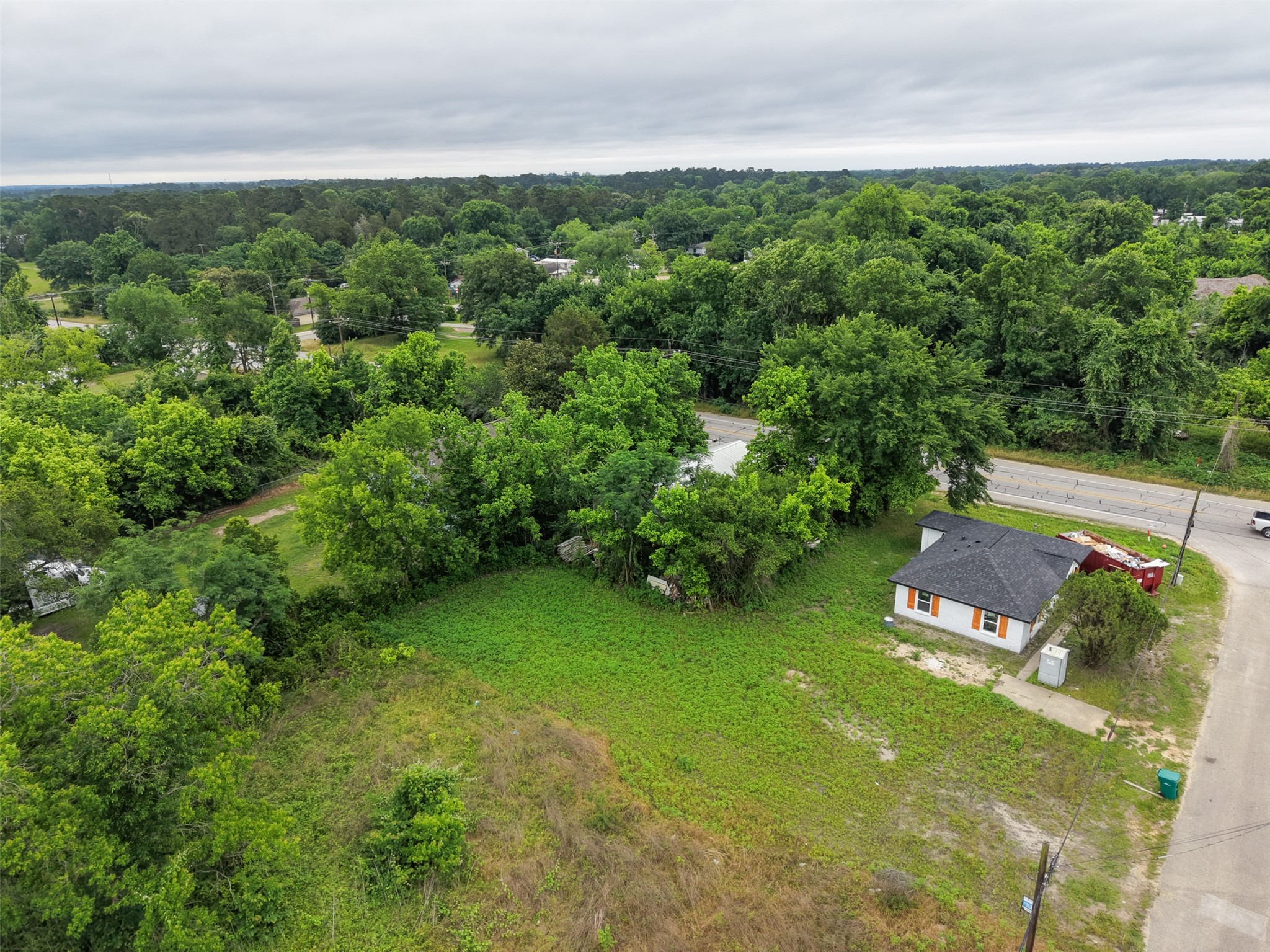 0 Mill Street Willis, TX 77378 - Photo 6 of 24 a view of a lush green forest with lawn chairs