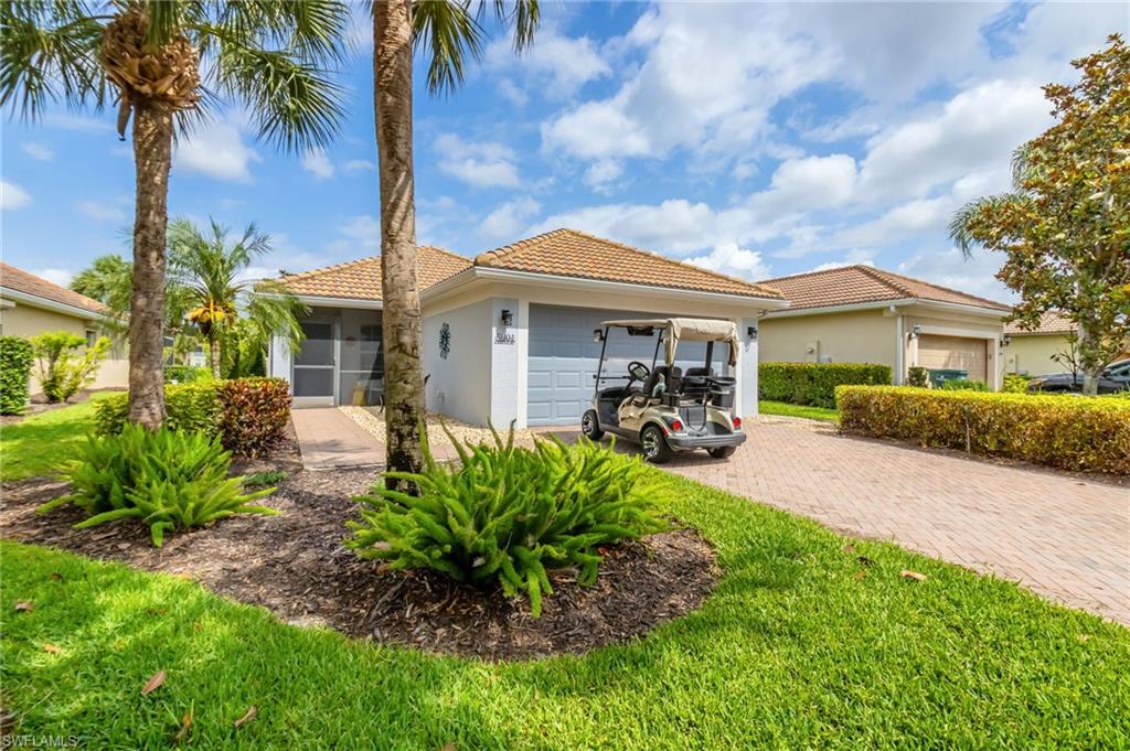 5801 Declaration Court Ave Maria, FL 34142 - Photo 3 of 38 a front view of a house with garden
