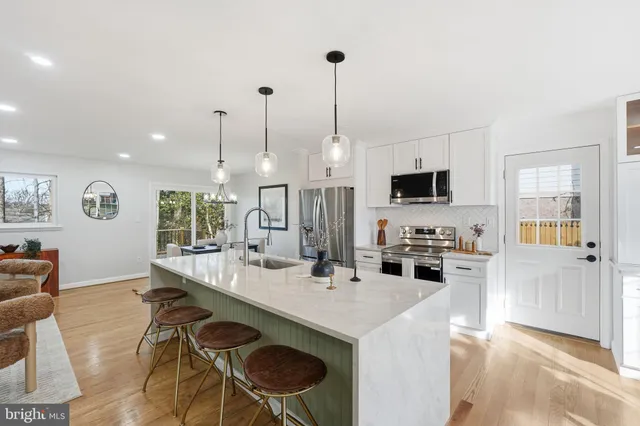 a living room with furniture potted plant and a lamp
