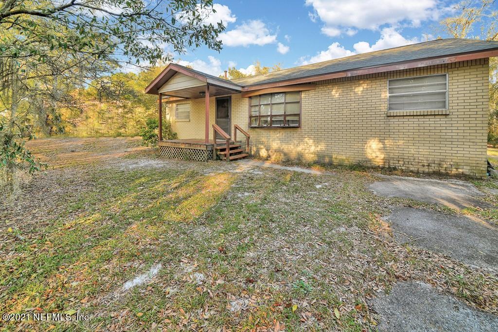 85076 Myrtice Road Yulee, FL 32097 - Photo 1 of 15 a front view of a house with a yard
