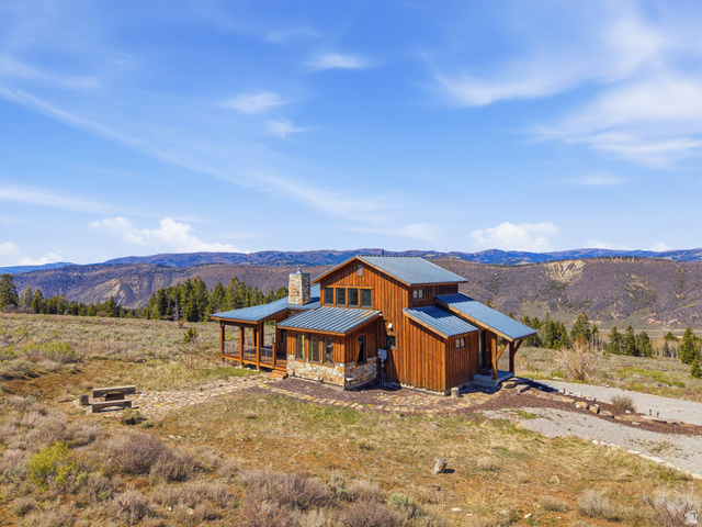 22677 East Snowbird Drive, Unit 47 Helper, UT 84526 - Photo 35 of 43 Contemporary house with a mountain view, a porch, board and batten siding, a standing seam roof, and a chimney