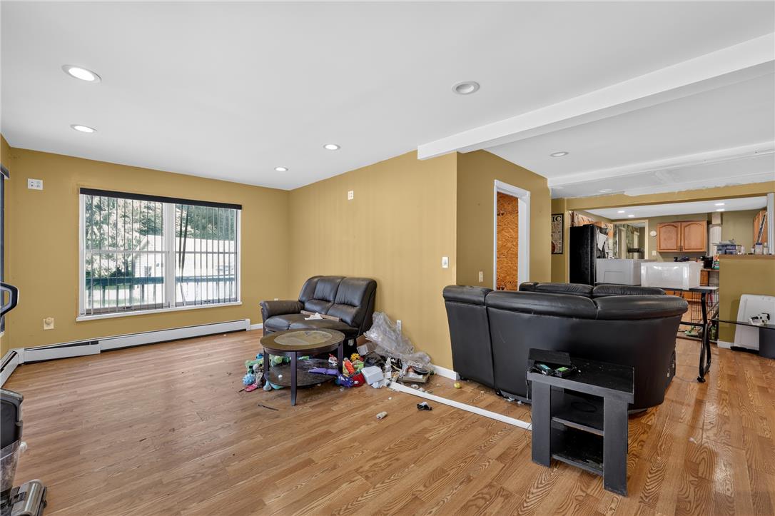 2882 Locust Ridge Road Pocono Lake, PA 18347 - Photo 40 of 45 Bright, spacious living area showcasing beautiful wood flooring and ample natural light.
