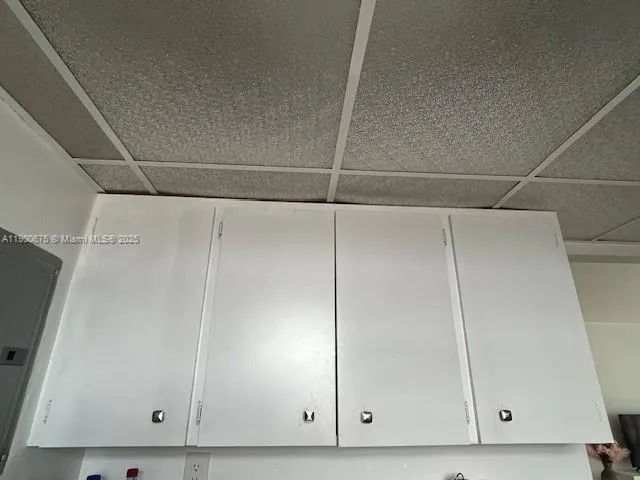 a spacious bathroom with a granite countertop sink a mirror and shower