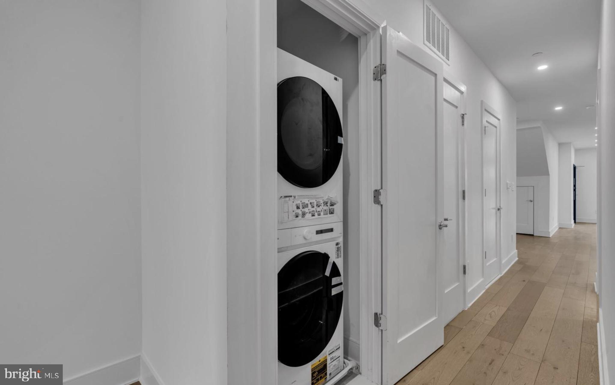 1121 Morse Street Northeast, Unit 2 Washington, DC 20002 - Photo 8 of 11 a view of a hallway with washer and dryer