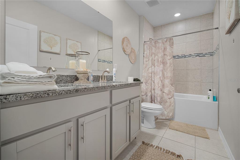 418 Fleming Street Sebastian, FL 32958 - Photo 26 of 38 a bathroom with a double vanity sink toilet and shower
