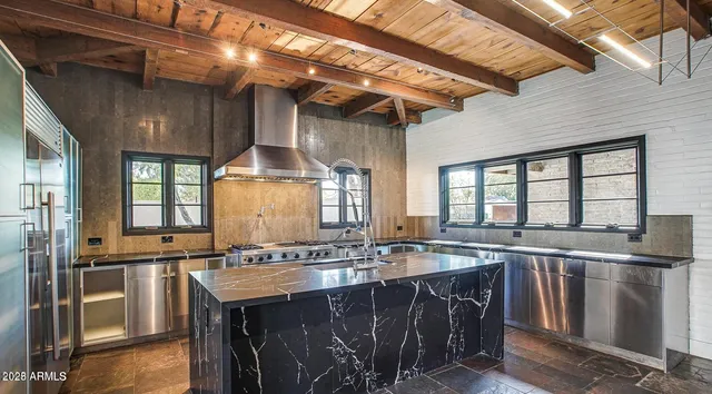 a kitchen with a stove a sink and a refrigerator