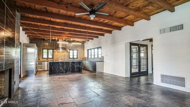 a empty room with wooden floor and windows