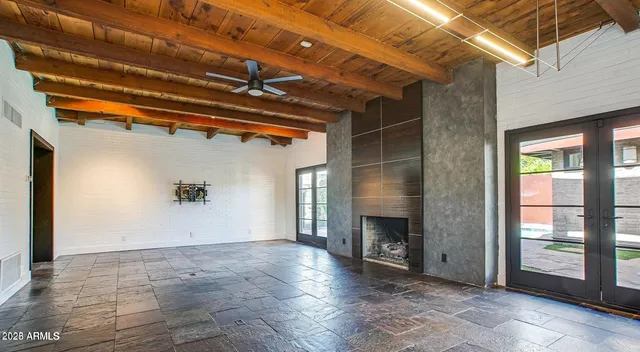 a view of an empty room with a fireplace