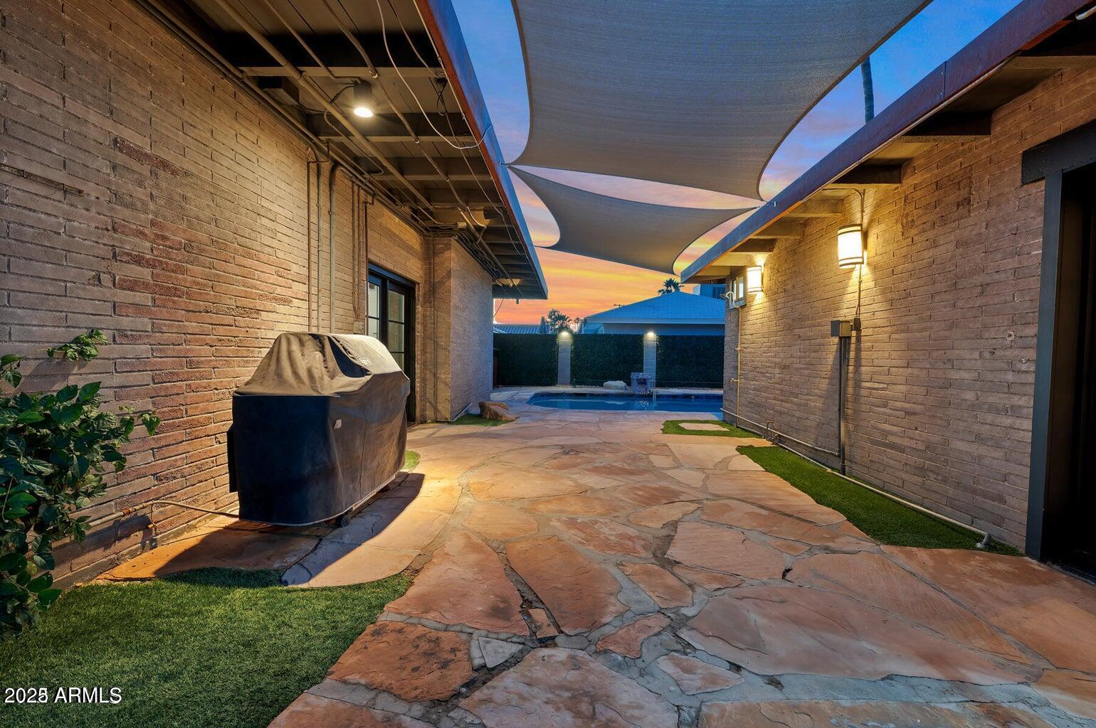 902 West Verde Lane Phoenix, AZ 85013 - Photo 34 of 44 a view of a porch with a floor to ceiling window and potted plants