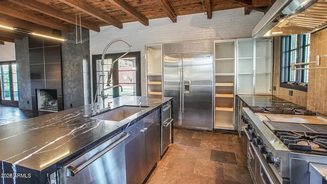 a kitchen with stainless steel appliances granite countertop a stove and a refrigerator