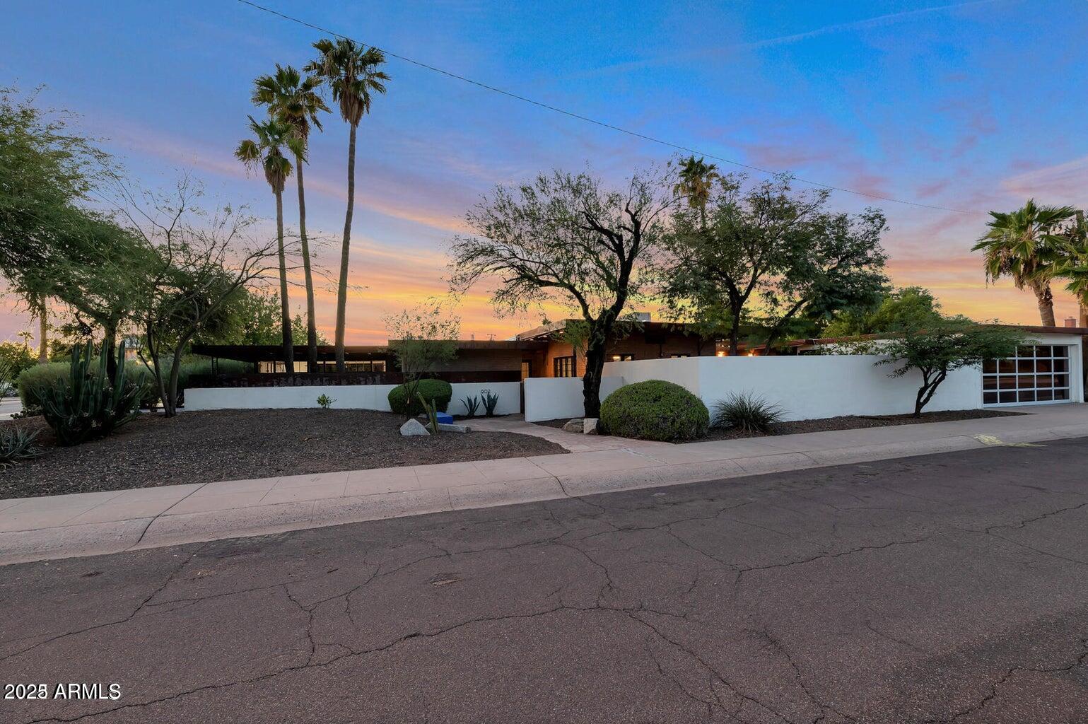 902 West Verde Lane Phoenix, AZ 85013 - Photo 6 of 44 a row of palm trees and a yard with wooden fence