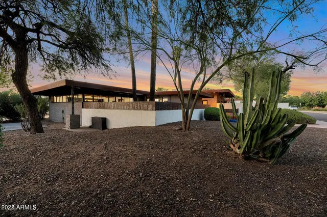 a view of a house with a tree in a yard