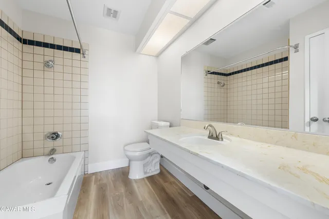 a bathroom with a sink a toilet and bathtub