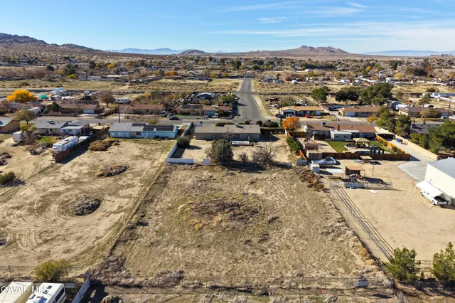 an aerial view of a house with a mountain