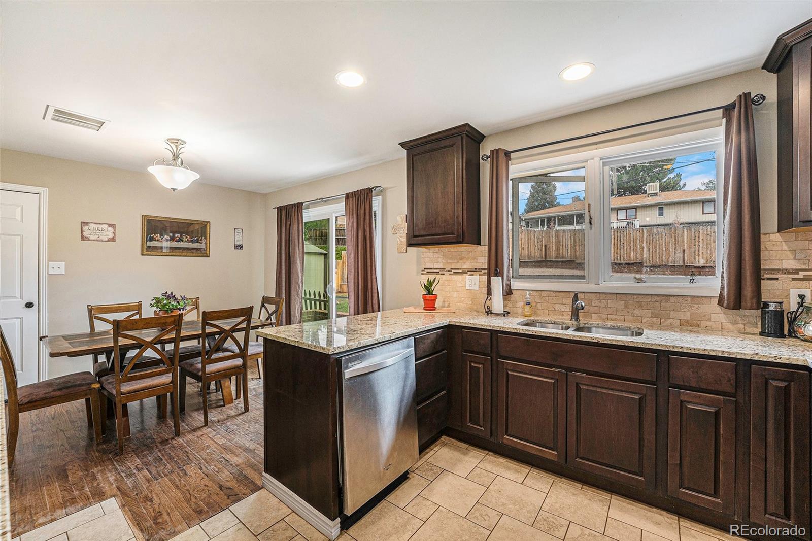 2872 South Gray Way Denver, CO 80227 - Photo 11 of 35 a kitchen with lots of counter top space and dining table