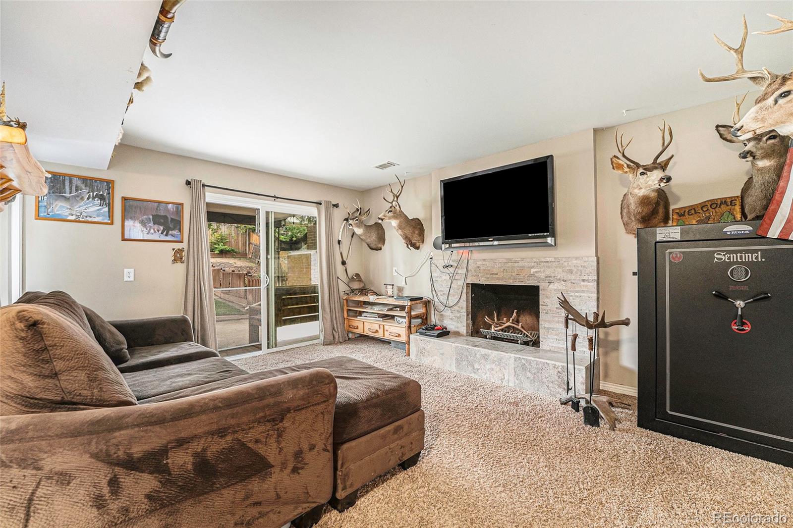 2872 South Gray Way Denver, CO 80227 - Photo 14 of 35 a living room with furniture a flat screen tv and a fireplace
