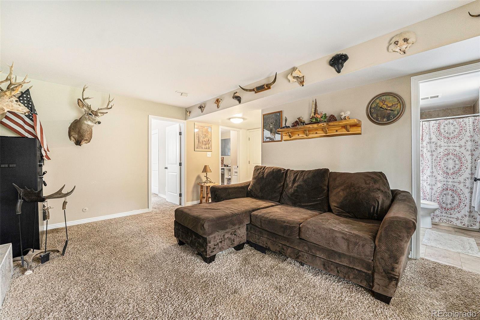 2872 South Gray Way Denver, CO 80227 - Photo 15 of 35 a living room with furniture and a clock