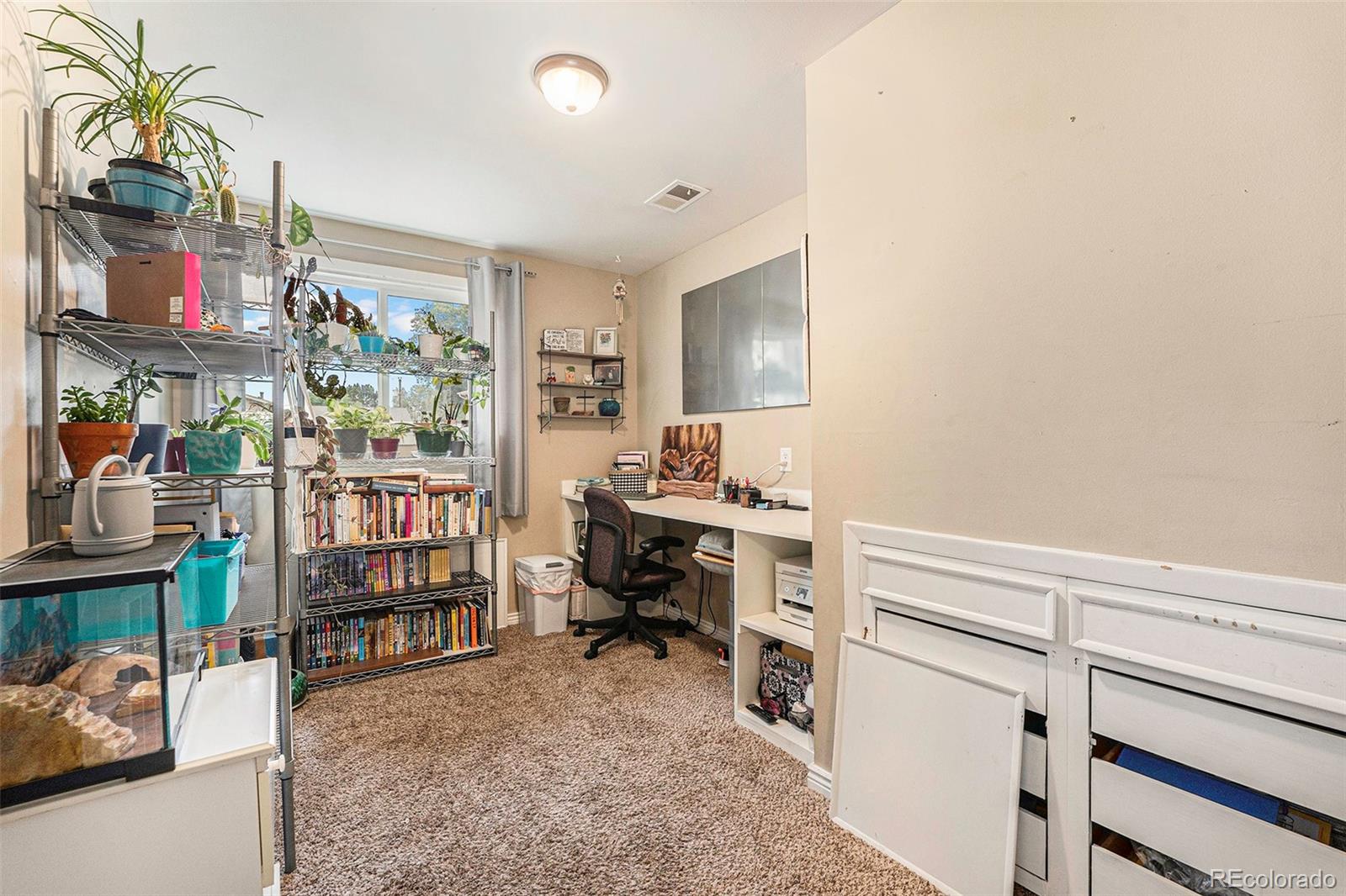 2872 South Gray Way Denver, CO 80227 - Photo 18 of 35 a room with furniture and a book shelf