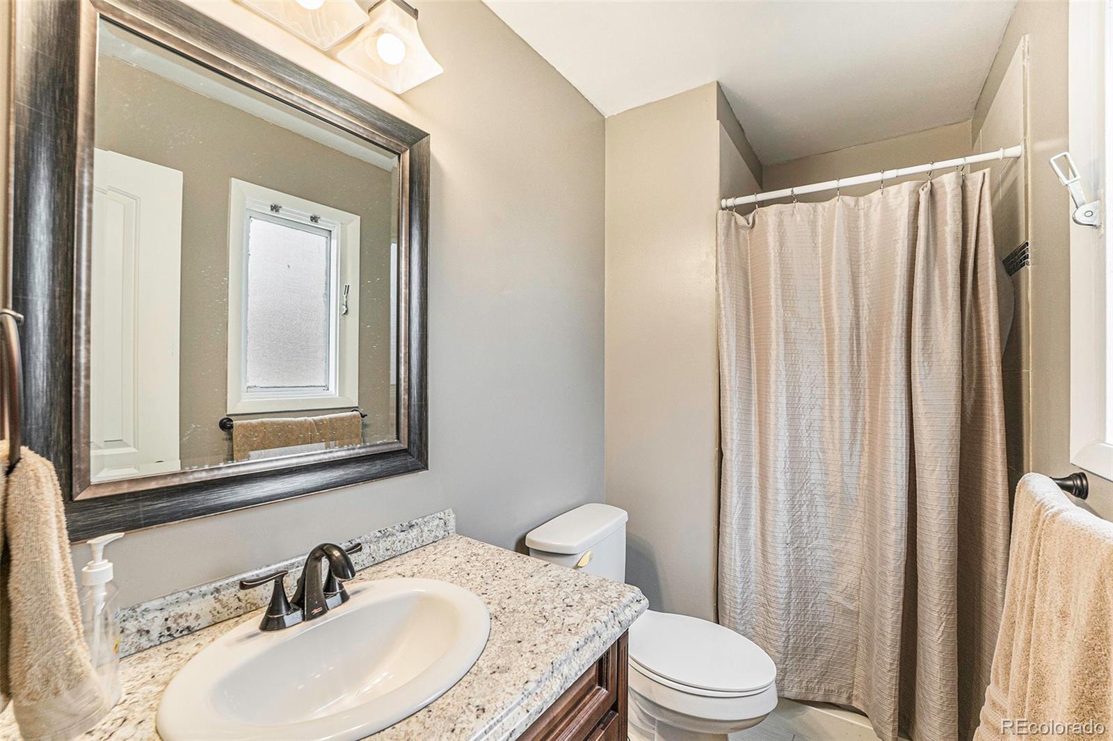 2872 South Gray Way Denver, CO 80227 - Photo 20 of 35 a bathroom with a sink a toilet and shower