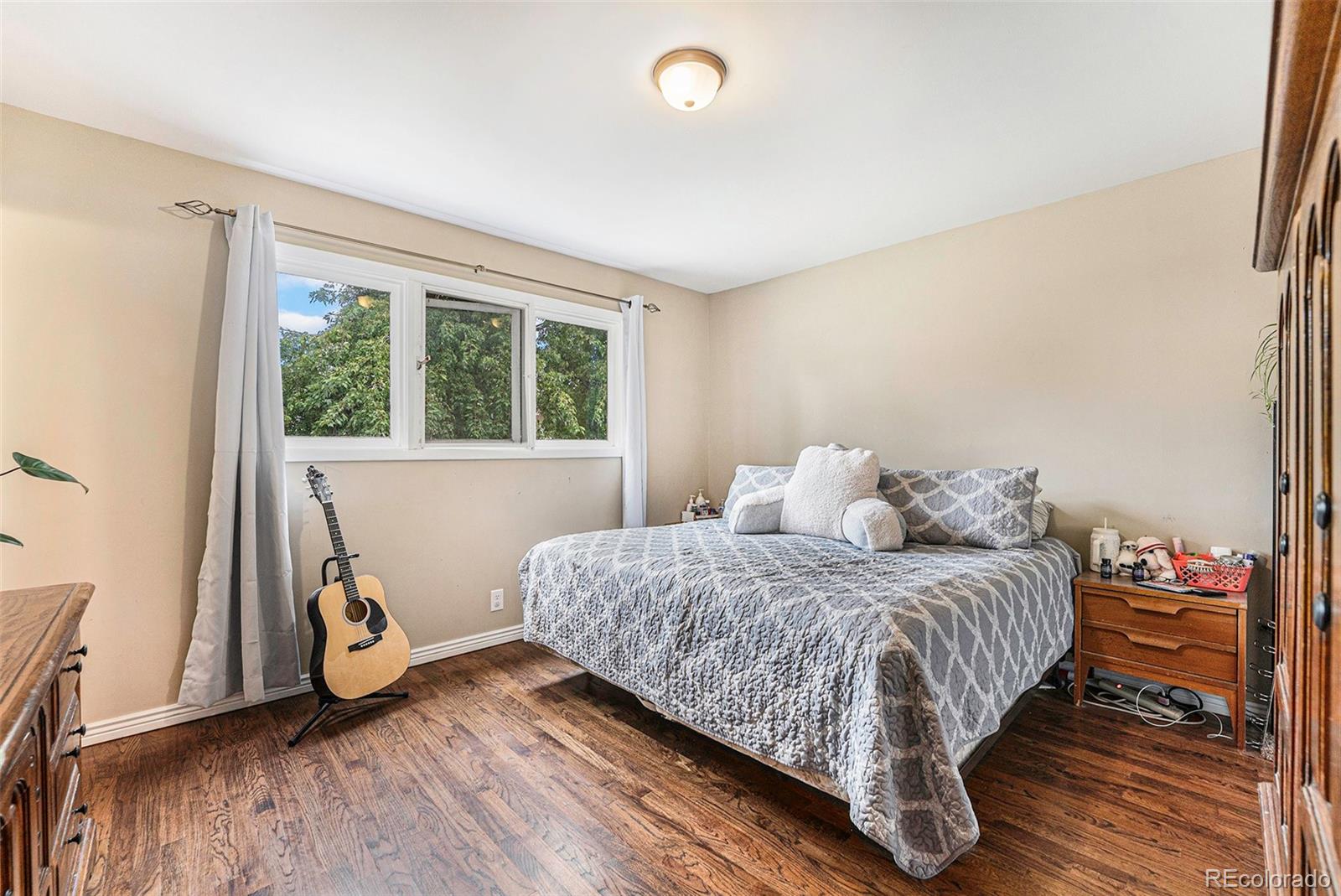 2872 South Gray Way Denver, CO 80227 - Photo 21 of 35 a bedroom with a bed and a wooden floor