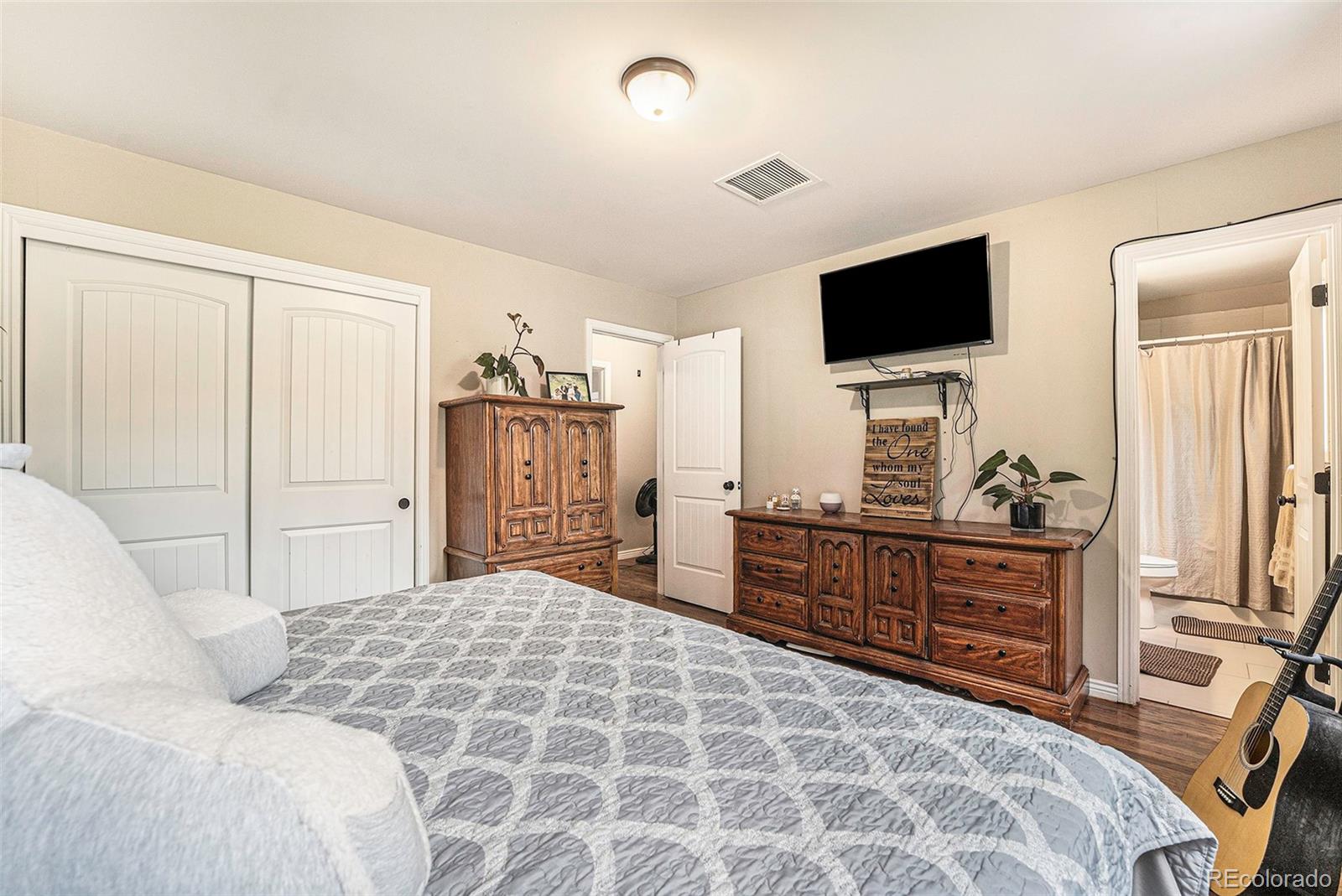 2872 South Gray Way Denver, CO 80227 - Photo 22 of 35 a bed room with a bed and a television