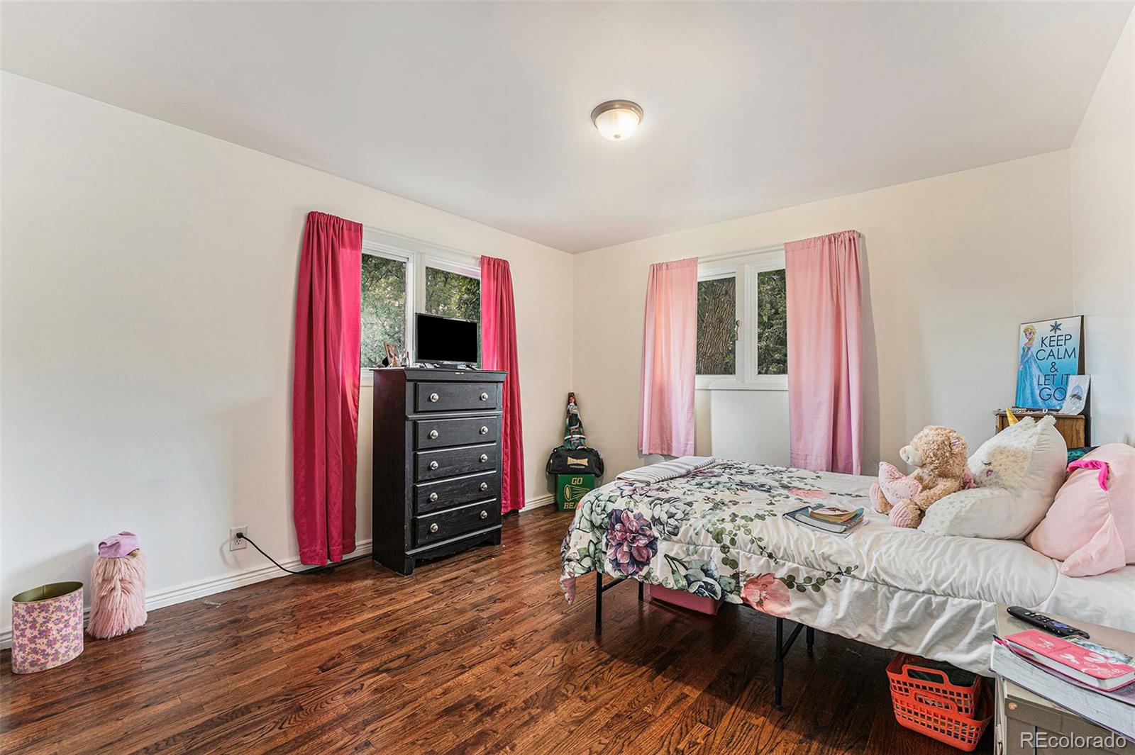 2872 South Gray Way Denver, CO 80227 - Photo 24 of 35 a bedroom with a bed and a wooden floor